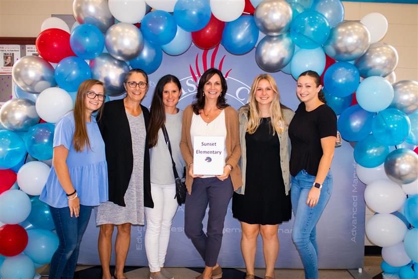 A group of teachers smile